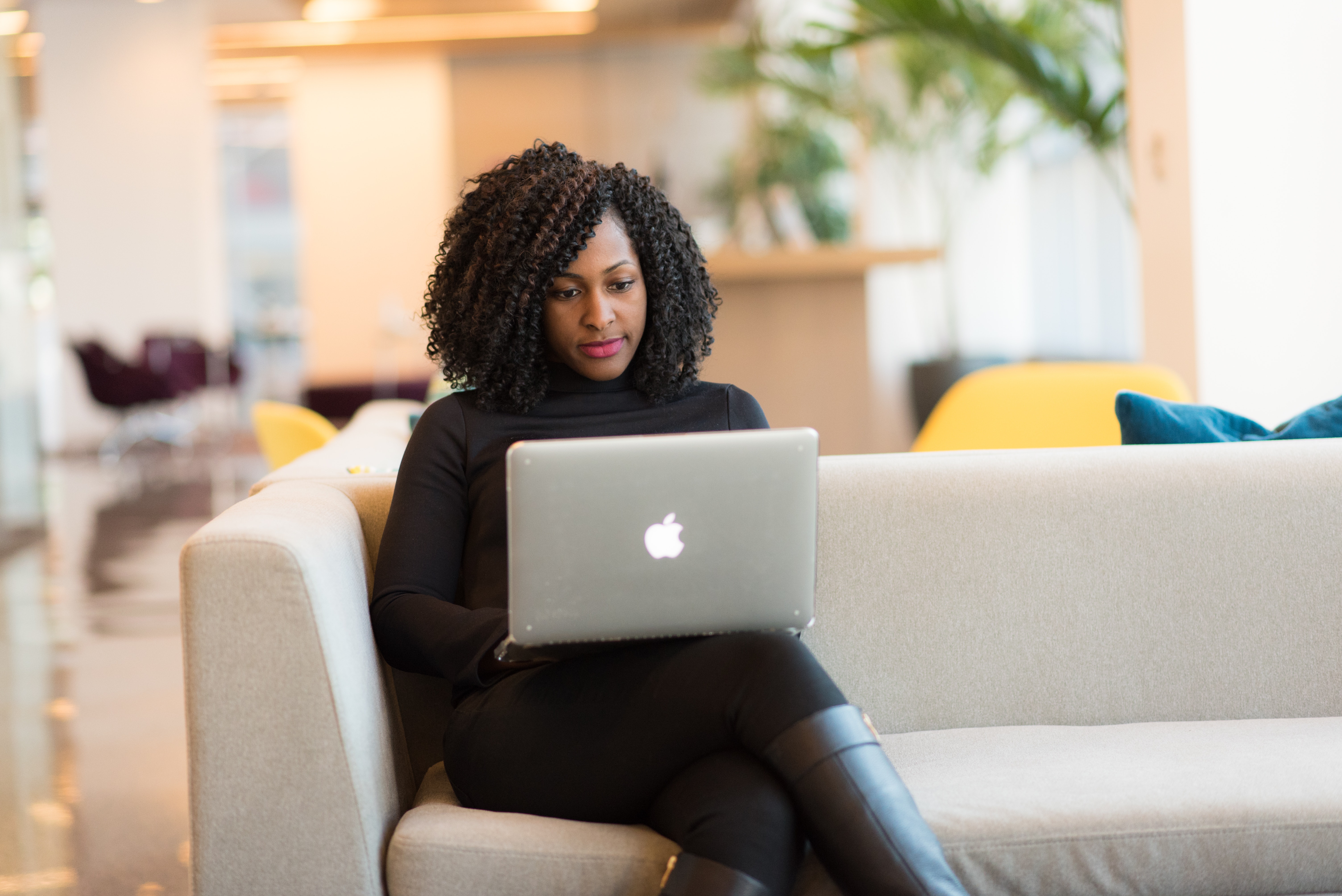 woman using macbook computer